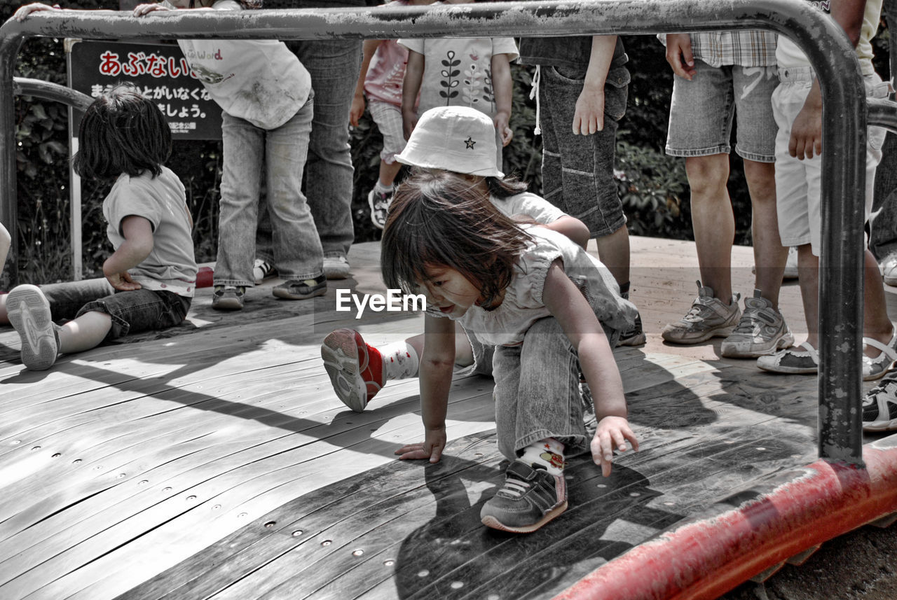 Boys and girls on slide in playground