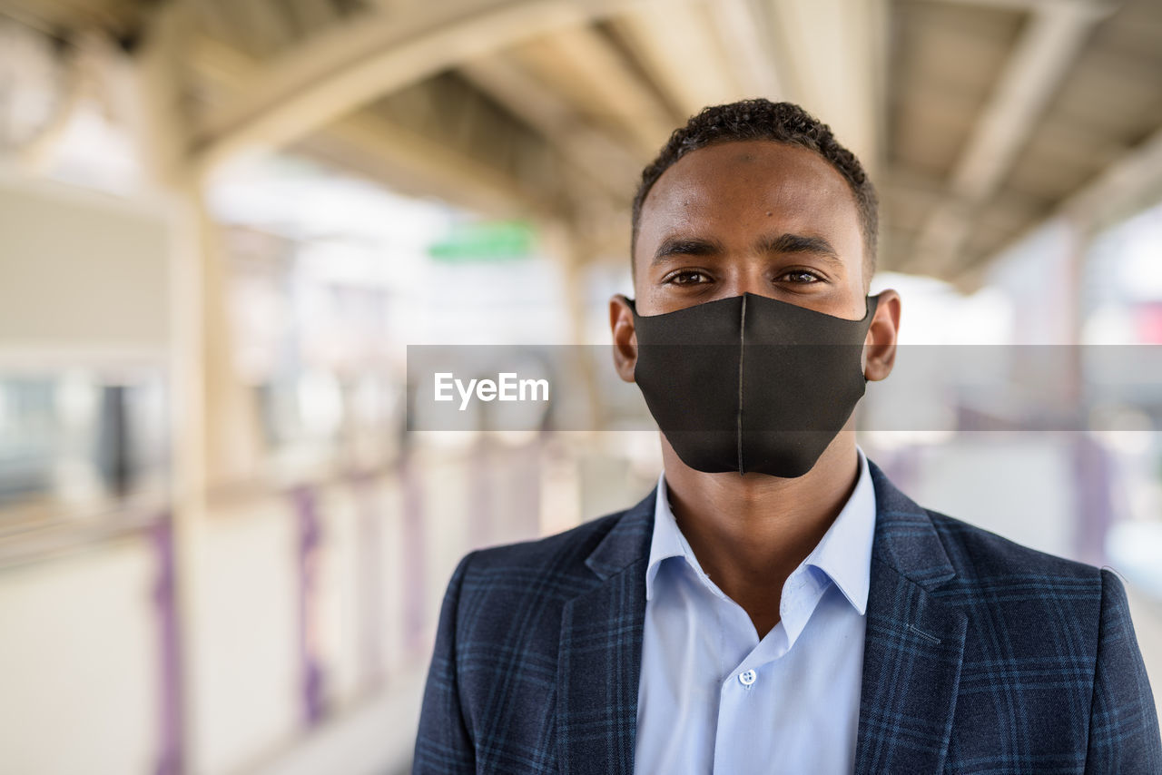 PORTRAIT OF A YOUNG MAN WEARING MASK