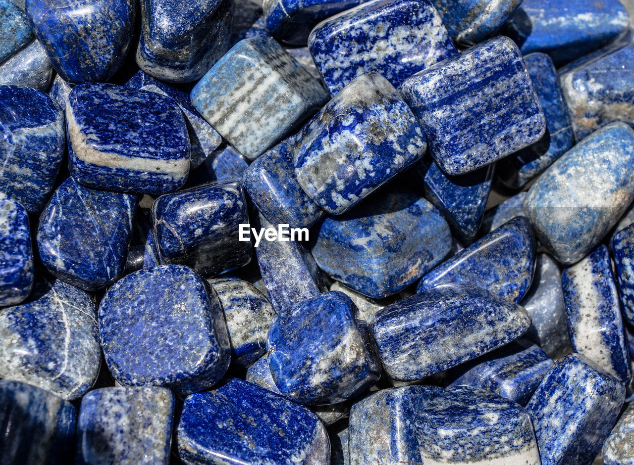 FULL FRAME SHOT OF STONES IN BLUE CONTAINER