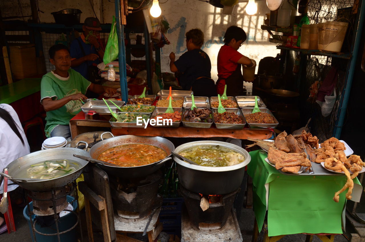 People preparing food for sale