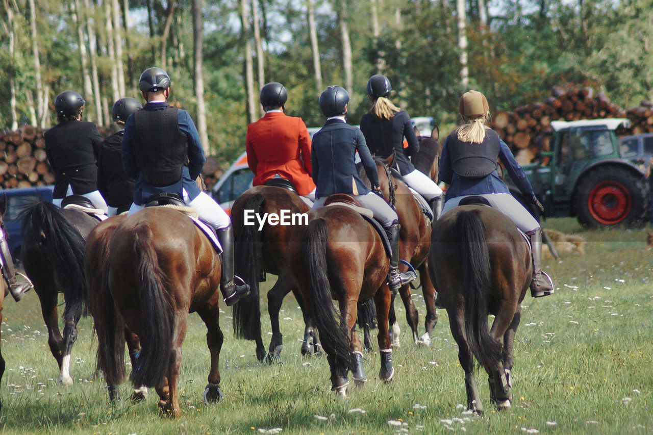 People riding horses on field at fuchsjagd 