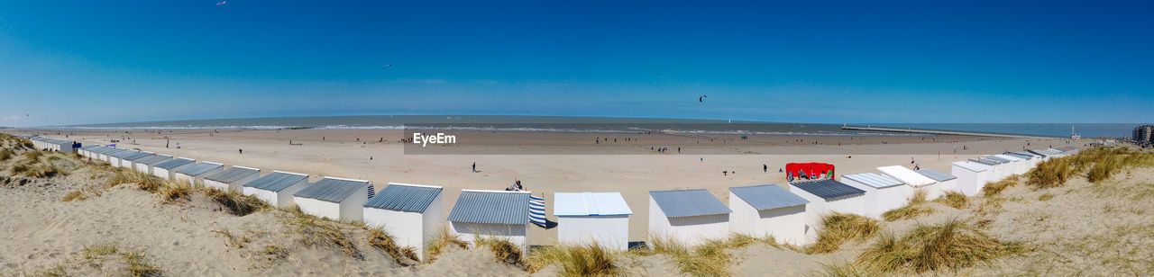 Panoramic view from a dune on the beach of nieuwpoort with strand cabins on a sunny springday