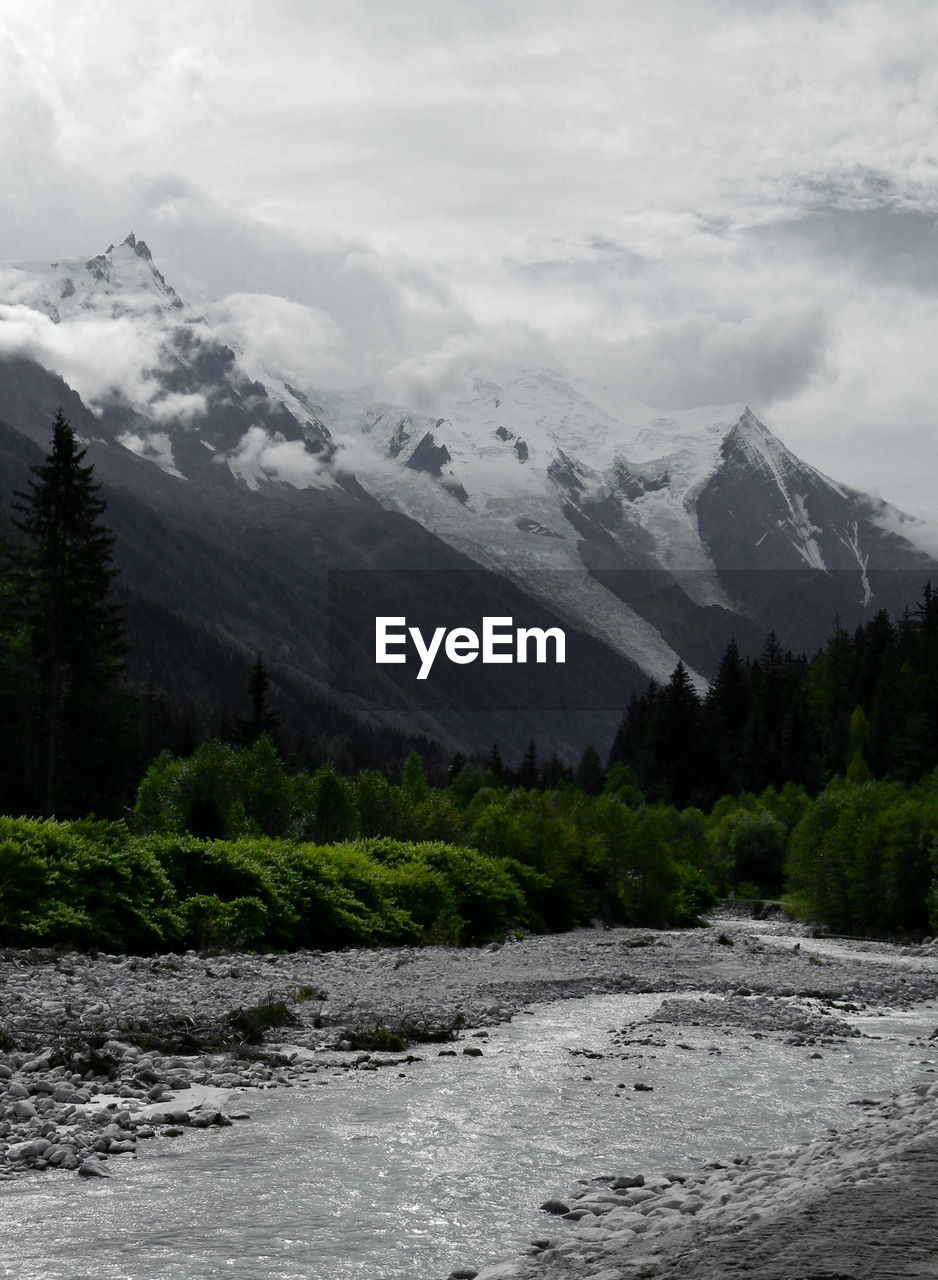 Scenic view of river and mountains against sky