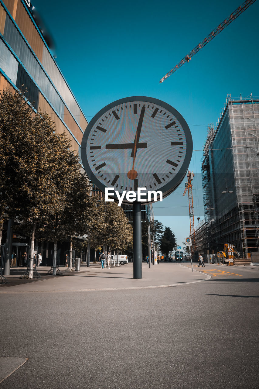 Low angle view of clock on city street