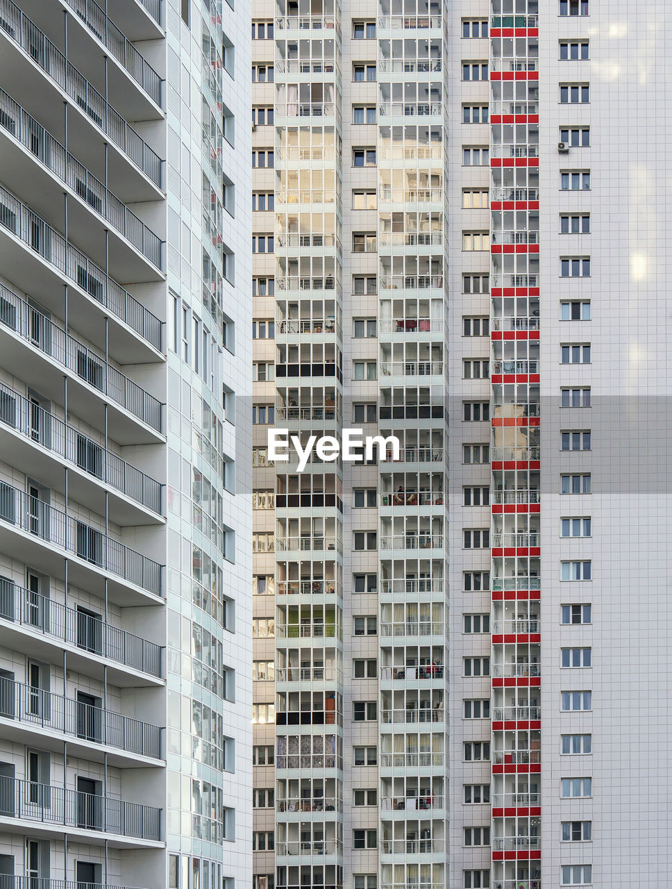 A large number of windows and balconies on building facade. apartment block. residential building