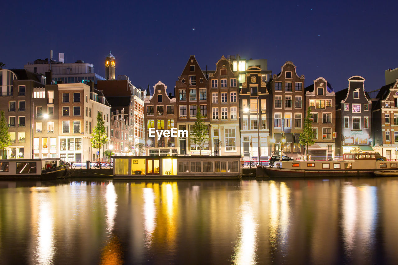 Reflection of buildings in city at night