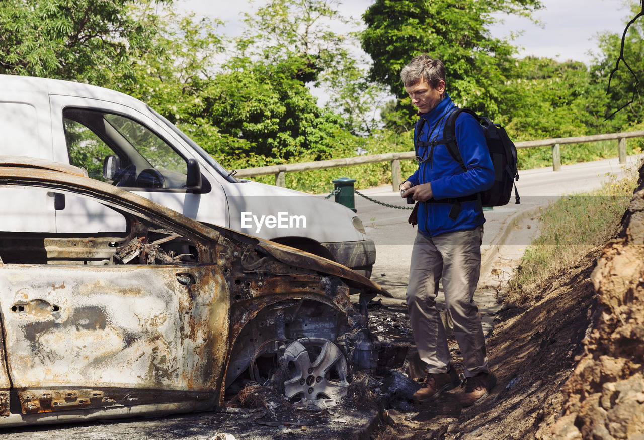 Full length of man standing by car