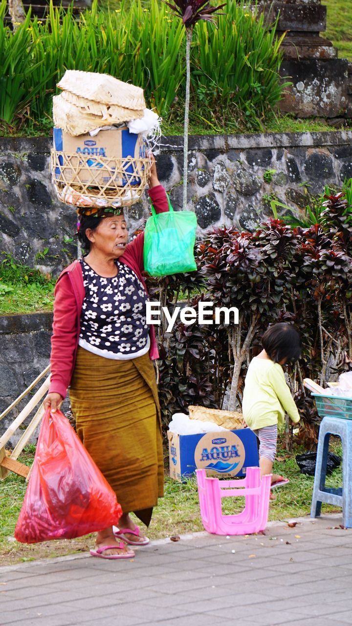 WOMAN WORKING AT TRADITIONAL CLOTHING