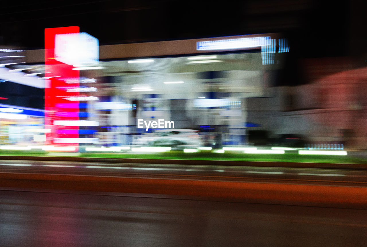 LIGHT TRAILS ON ROAD AT NIGHT