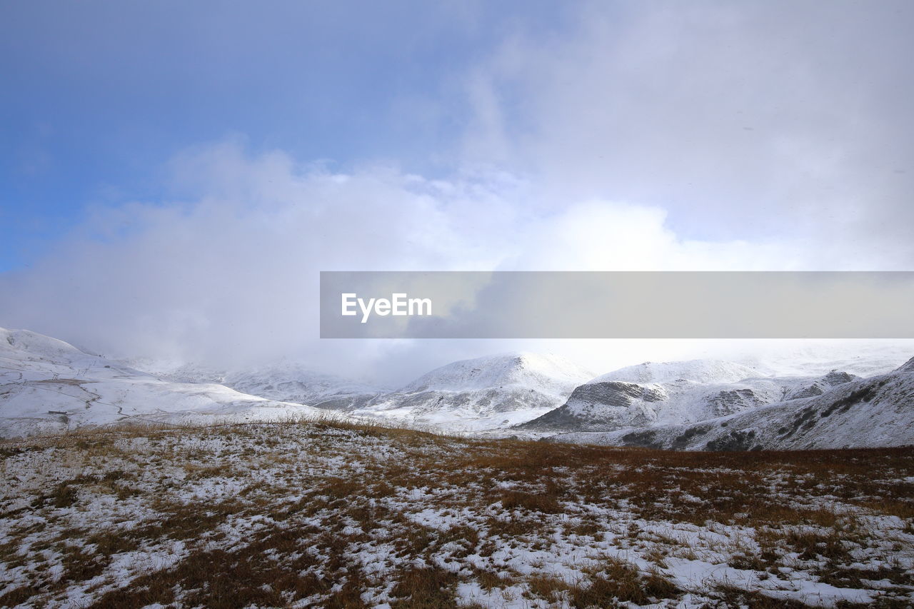 Scenic view of snowcapped mountains against sky