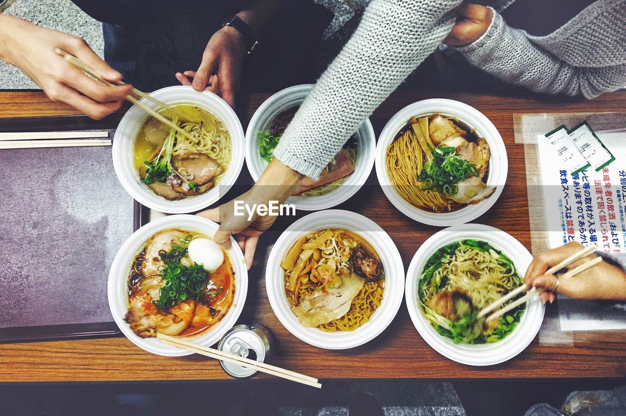 Cropped image of people having food in restaurant