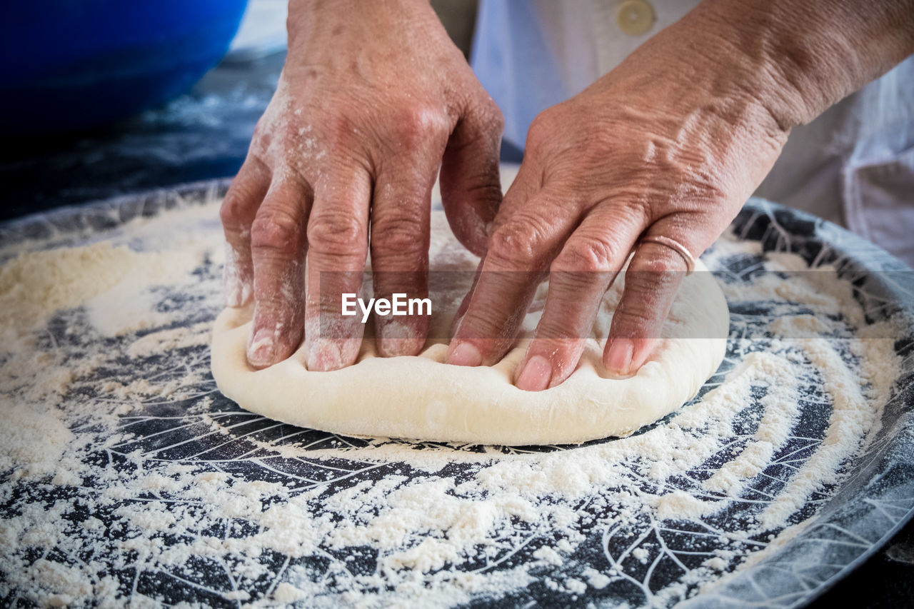 Cropped image of chef kneading dough