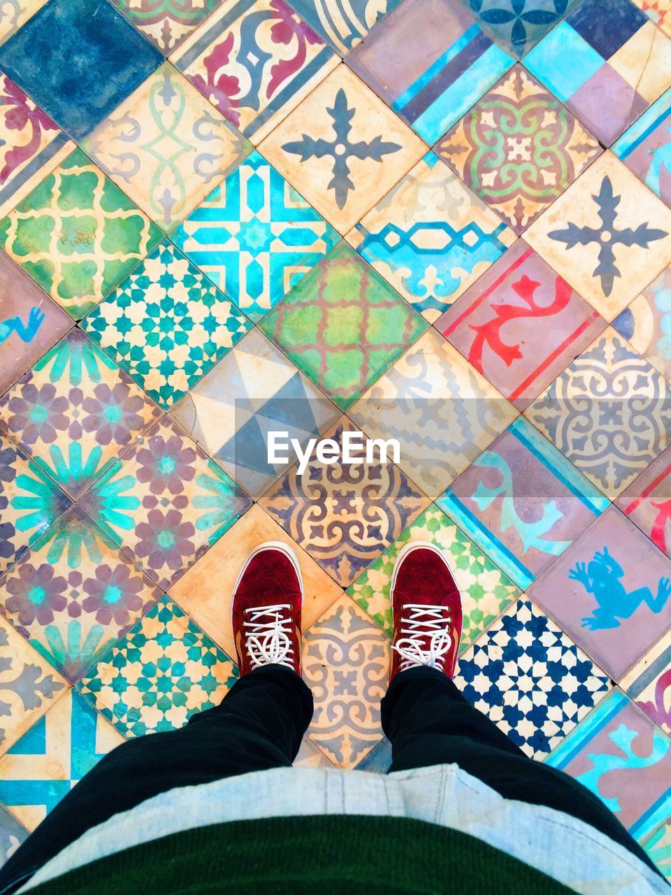 Woman standing on multi colored tiled floor