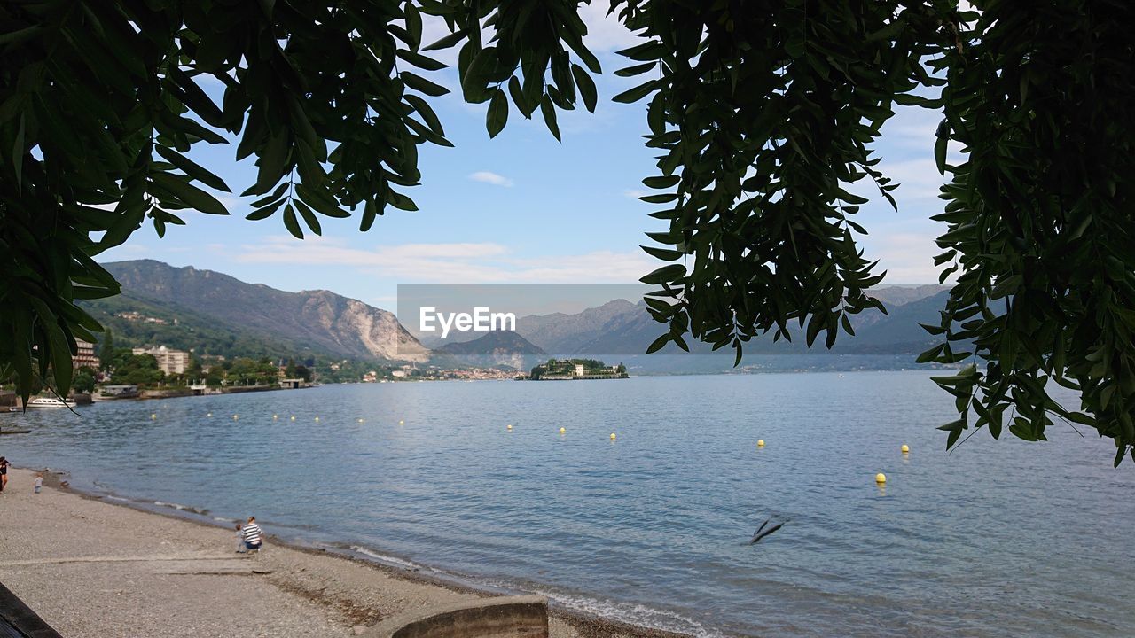 SCENIC VIEW OF SEA AGAINST MOUNTAINS