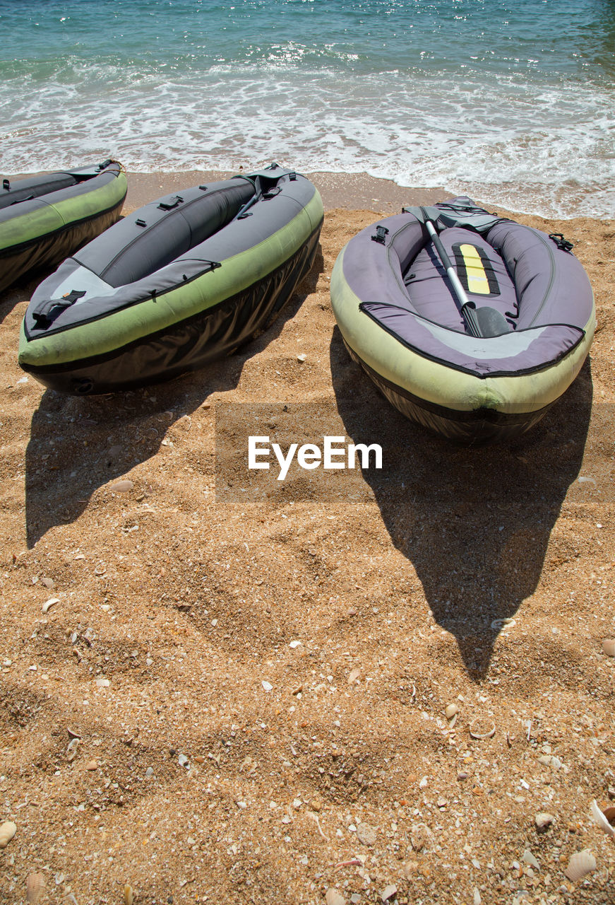 BOATS MOORED ON BEACH