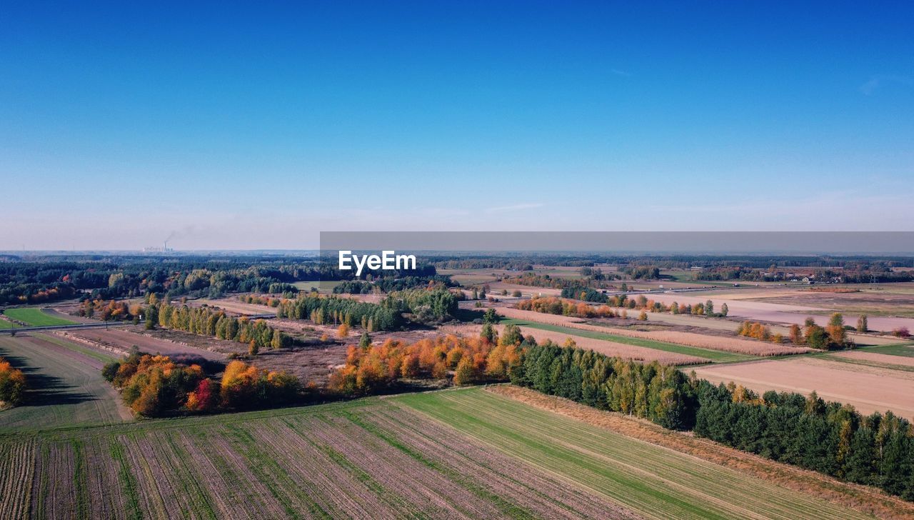 landscape, horizon, environment, sky, scenics - nature, land, hill, plant, field, rural scene, nature, plain, agriculture, blue, beauty in nature, rural area, aerial photography, no people, farm, tranquil scene, tranquility, growth, tree, architecture, day, high angle view, outdoors, city, clear sky, building, crop, vineyard, morning, cloud, idyllic, aerial view, copy space, horizon over land, dusk, sunny, built structure, travel