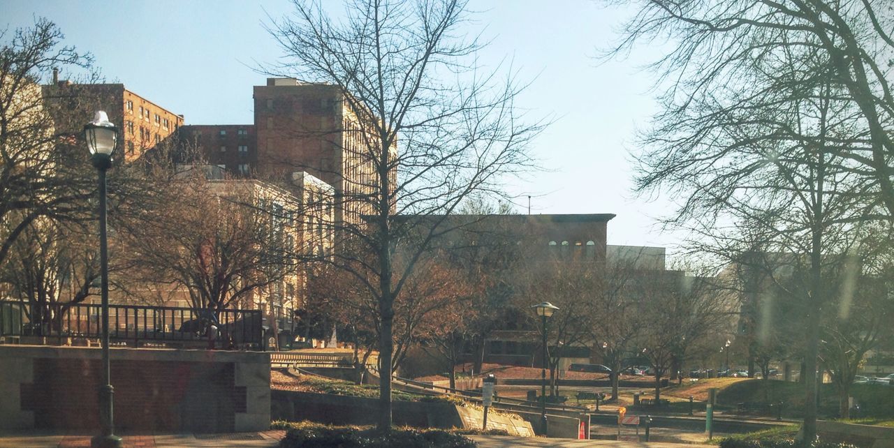 VIEW OF BUILDING WITH TREES IN BACKGROUND