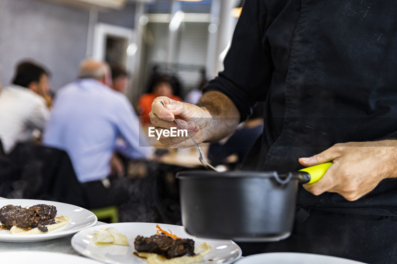 Group of people preparing food in restaurant