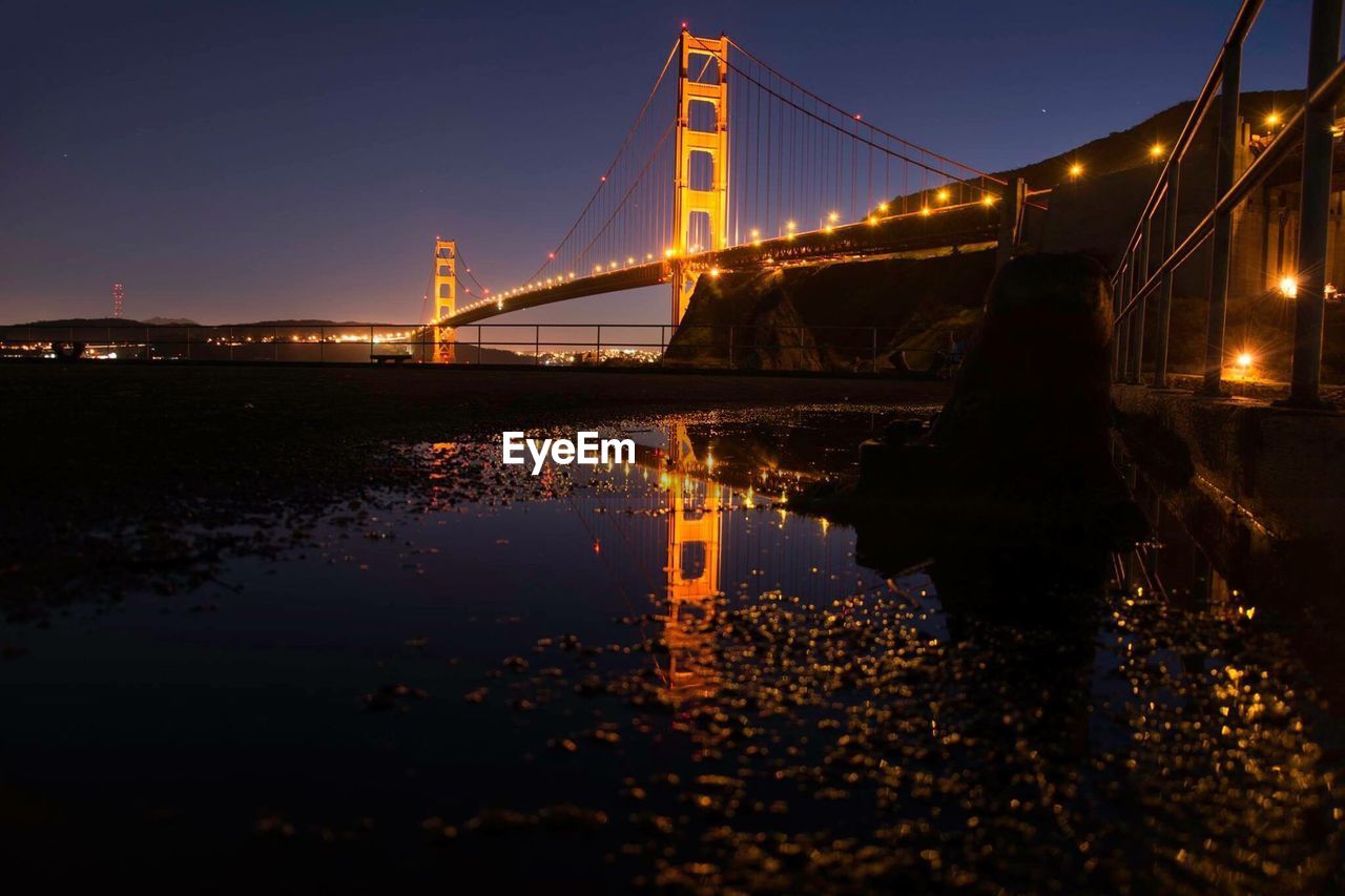 Low angle view of suspension bridge at night