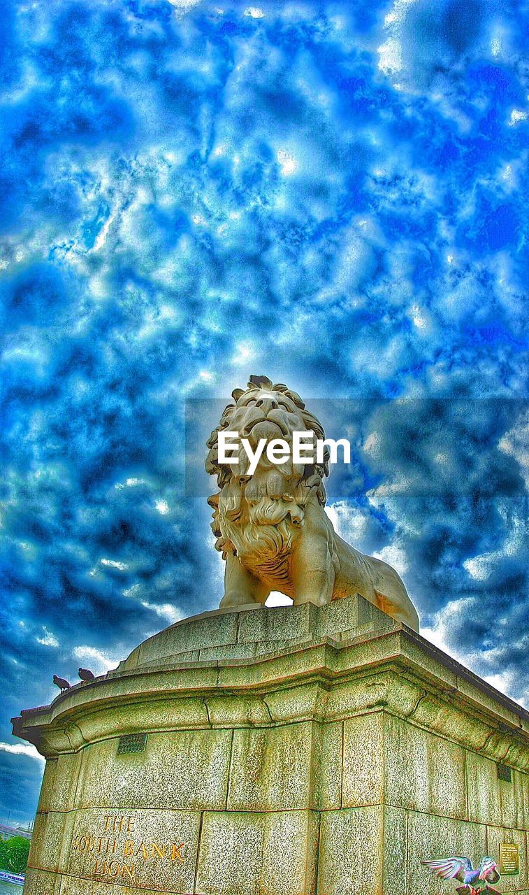 LOW ANGLE VIEW OF STATUE AGAINST CLOUDY SKY