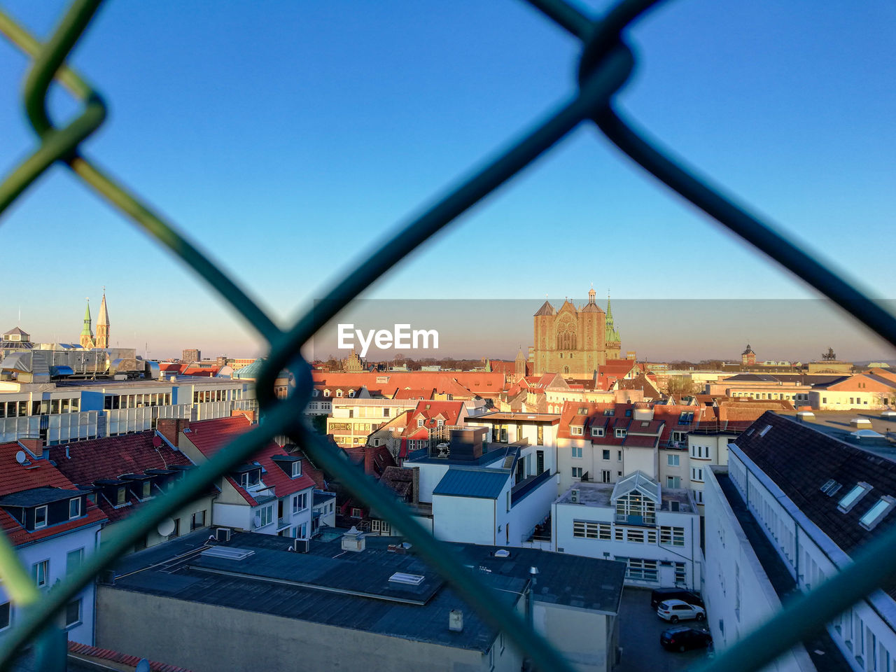 close-up of chainlink fence against sky during sunset