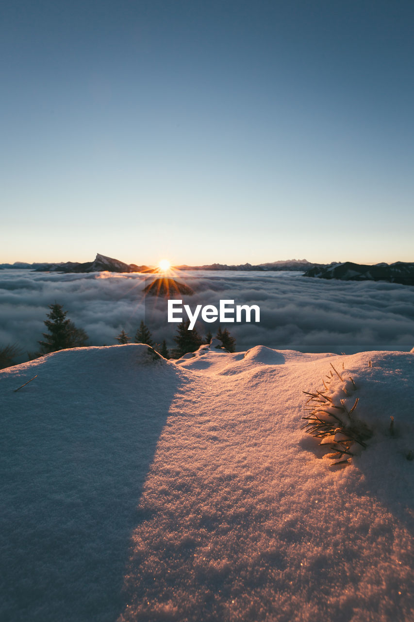 Scenic view of snowy landscape against sky during sunset