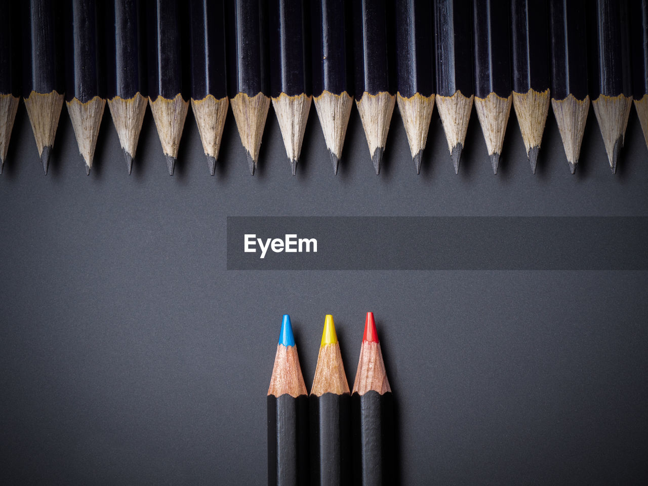 Close-up of colored pencils against black background