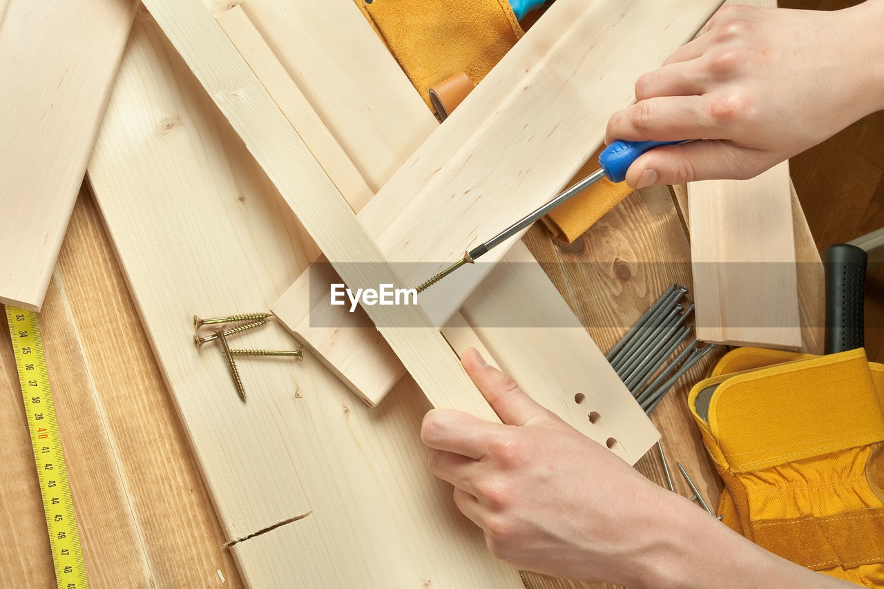 Close-up of carpenter cutting wood