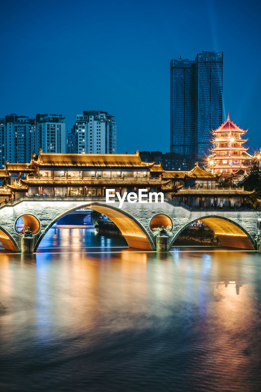 ARCH BRIDGE OVER RIVER IN CITY