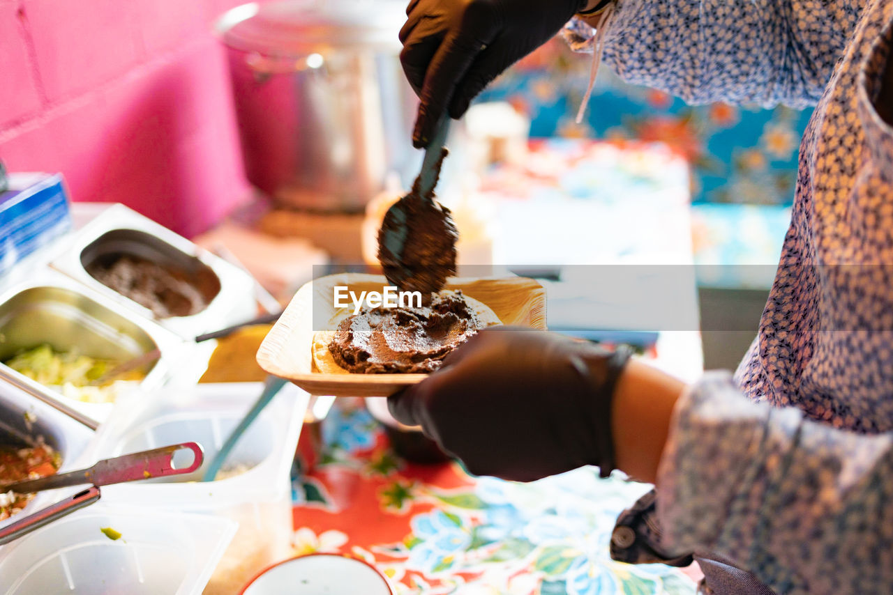 cropped hand of woman holding food