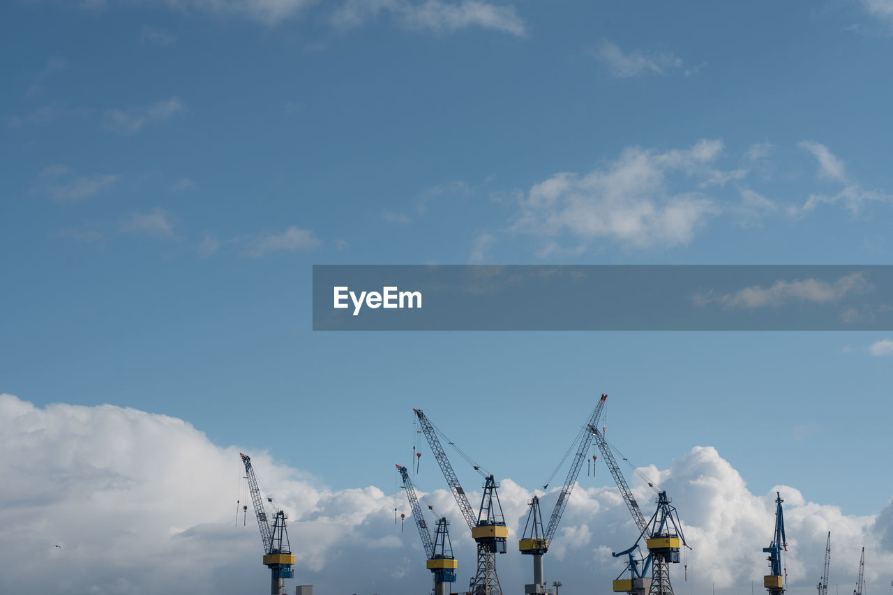 LOW ANGLE VIEW OF CRANE AGAINST SKY