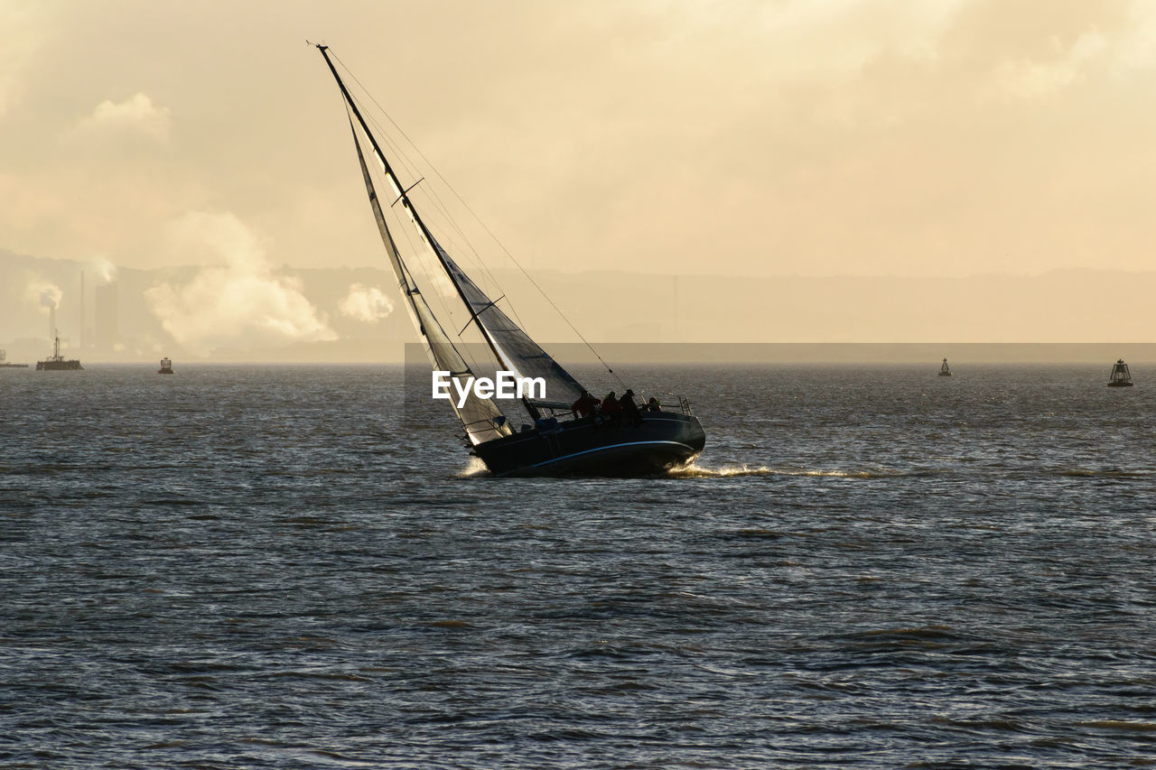 Ship sailing on sea against sky