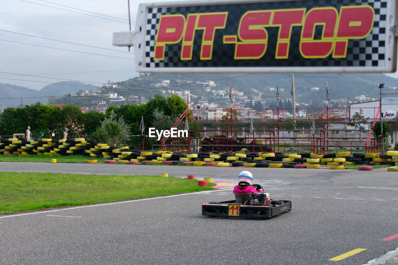 Girl riding motor vehicle on track