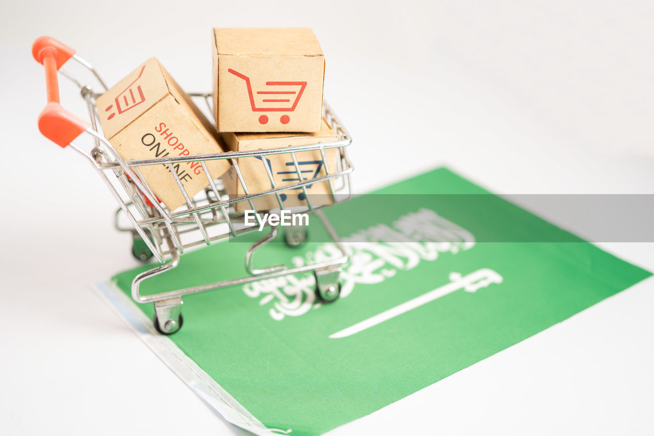 shopping cart, shopping, no people, consumerism, retail, finance, indoors, business, studio shot, green, communication, paper, cut out