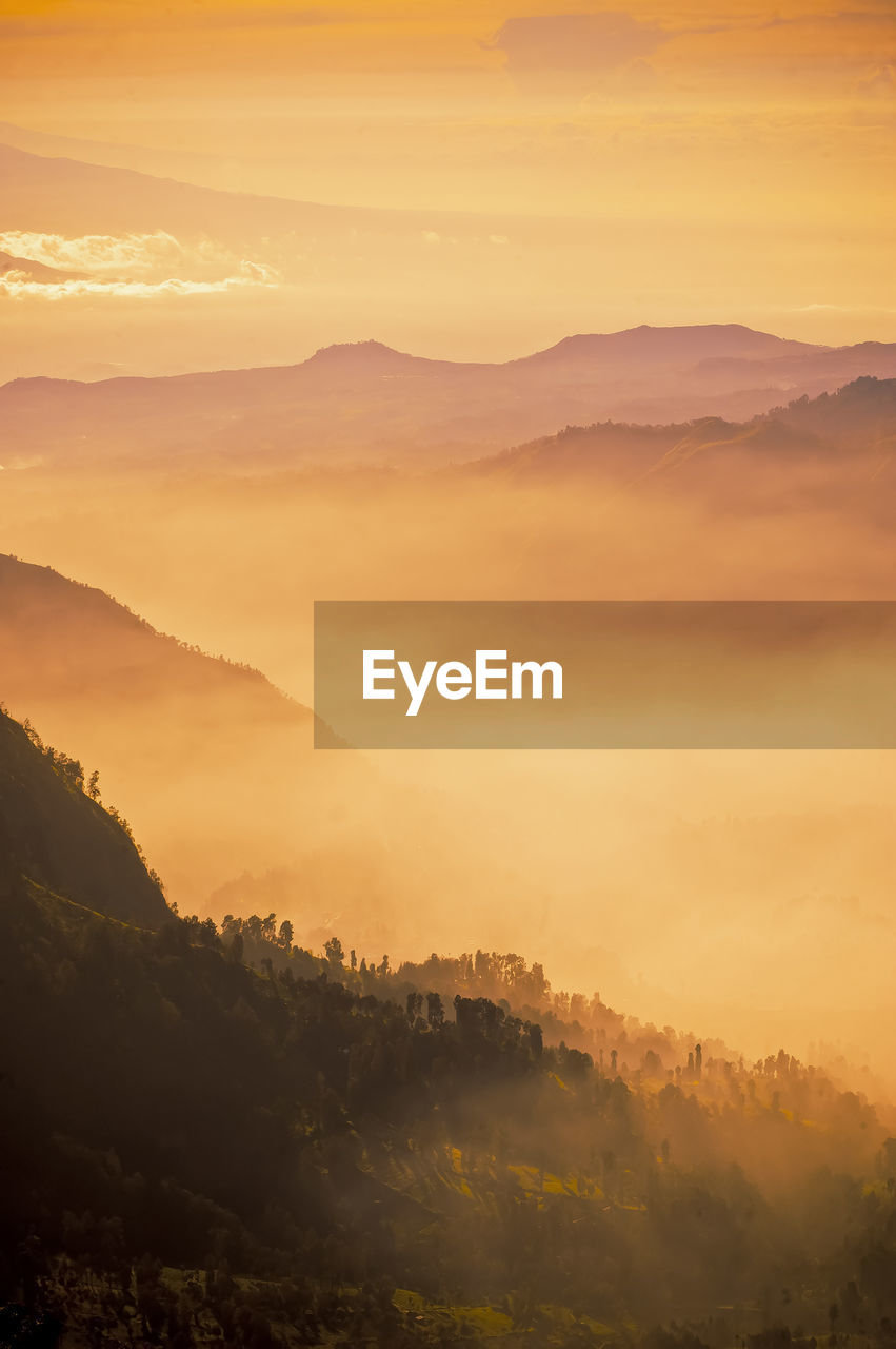 Scenic view of mountains against sky during sunrise