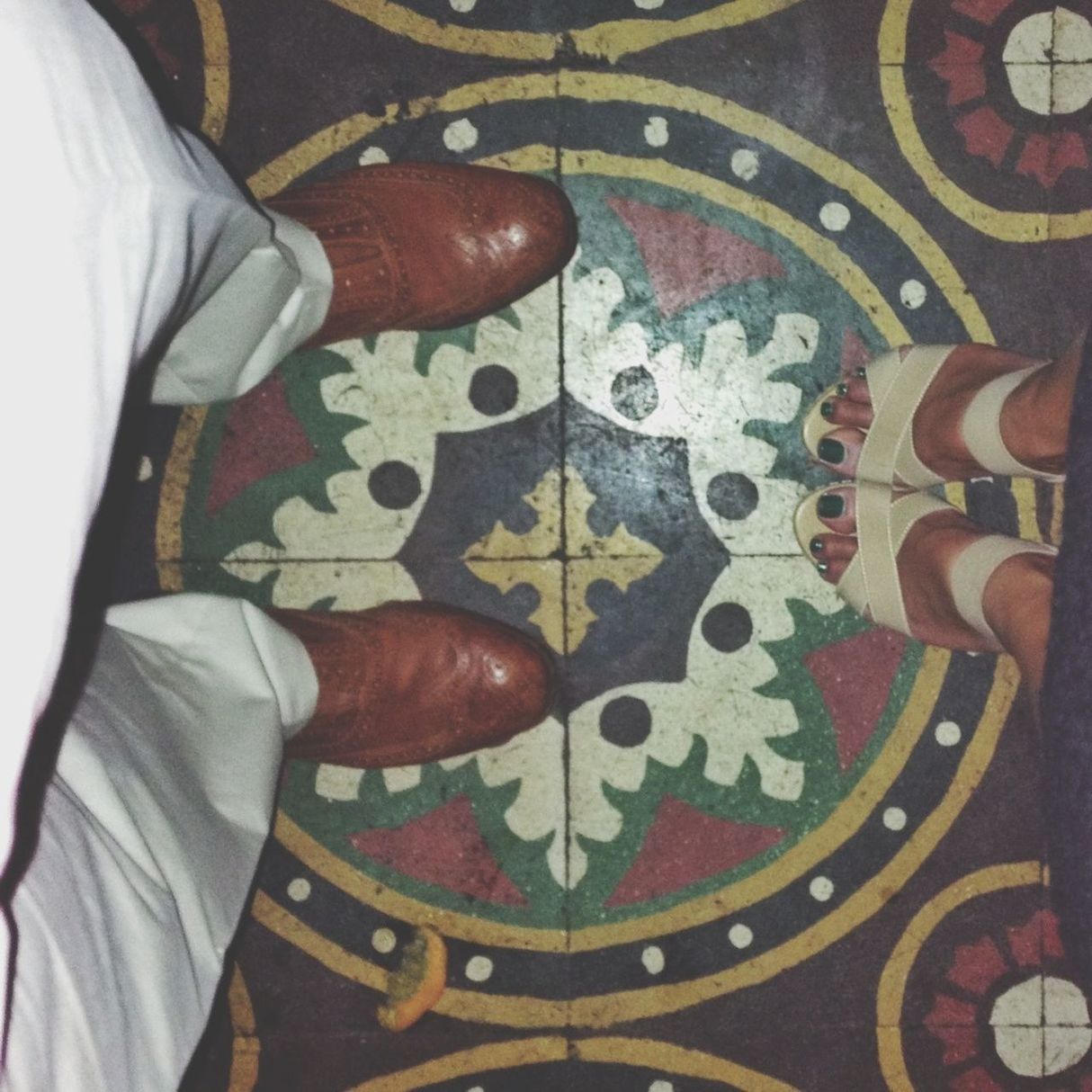 LOW SECTION OF WOMAN STANDING ON TILED FLOOR
