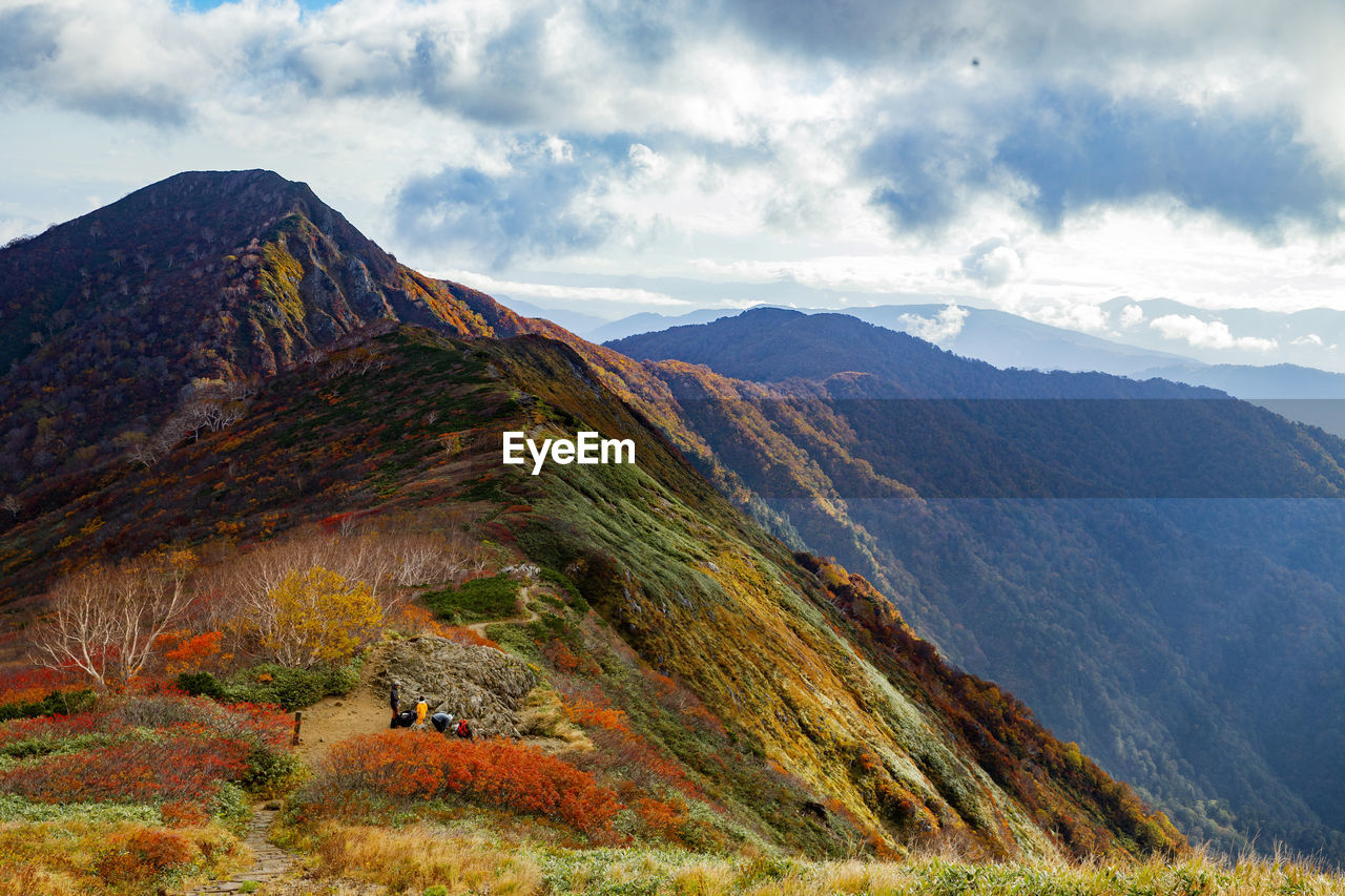 Scenic view of mountains against cloudy sky