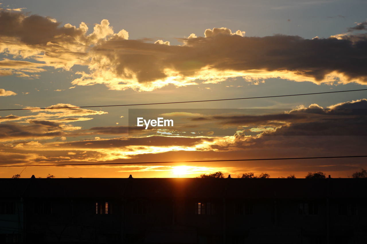 SCENIC VIEW OF DRAMATIC SKY OVER SILHOUETTE DURING SUNSET