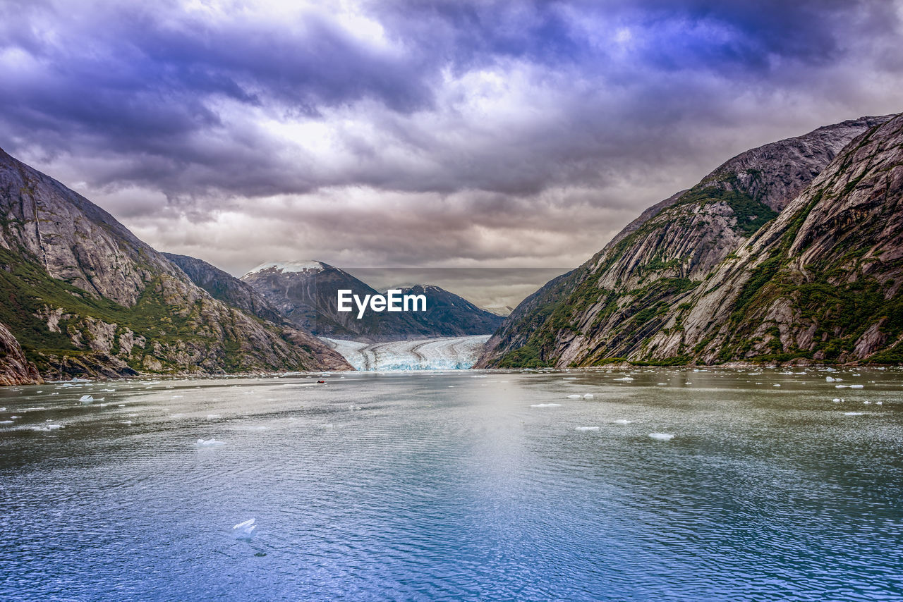 Scenic view of lake and mountains against sky