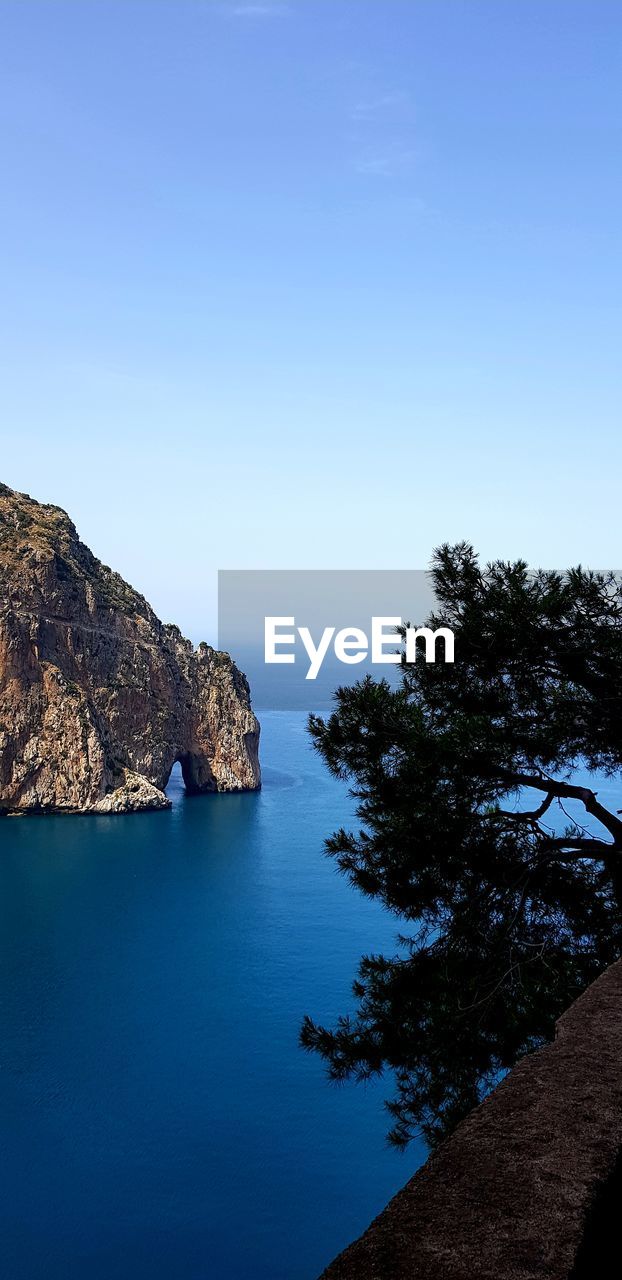 Scenic view of sea against clear blue sky