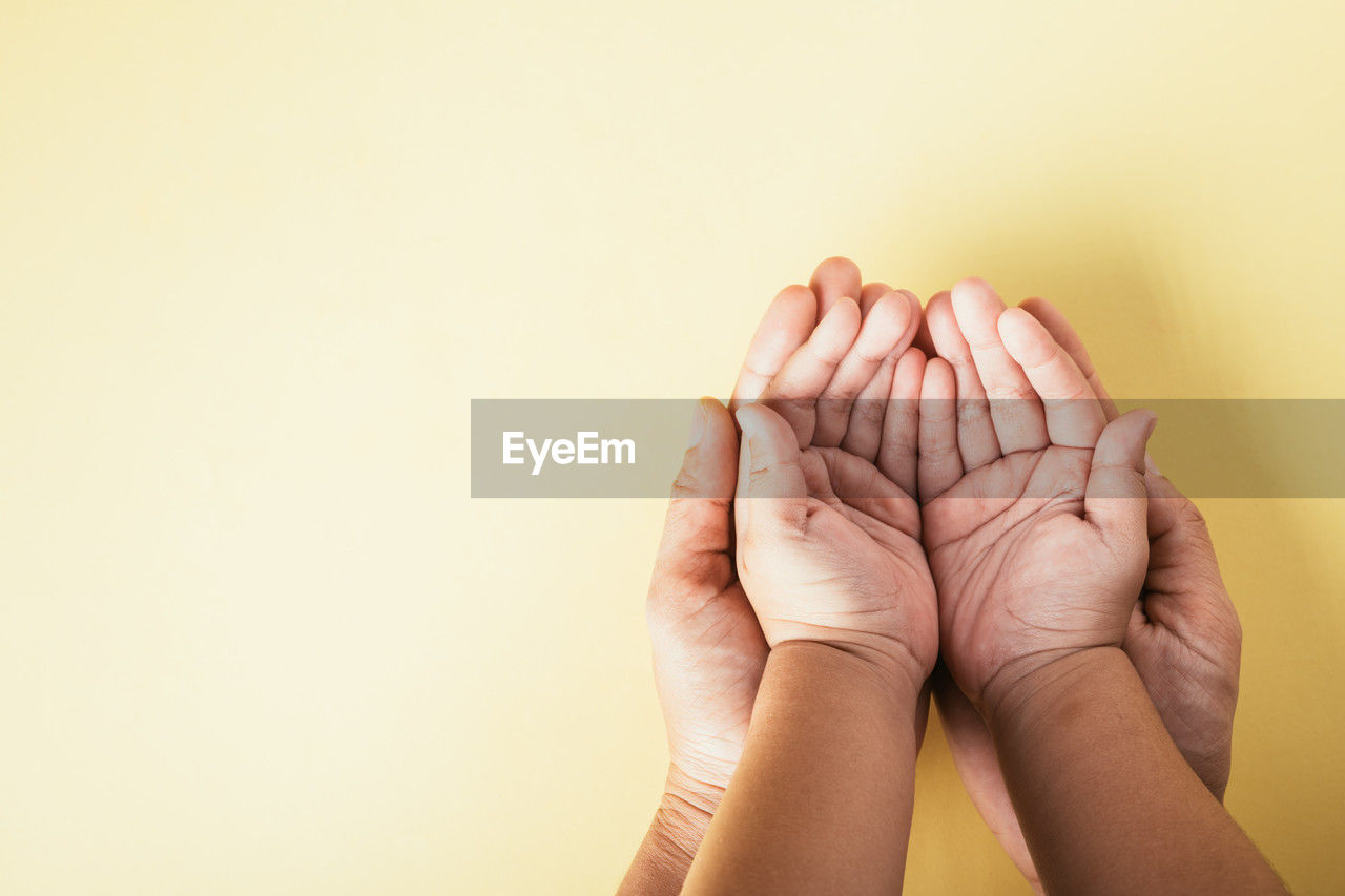 cropped image of hand against pink background