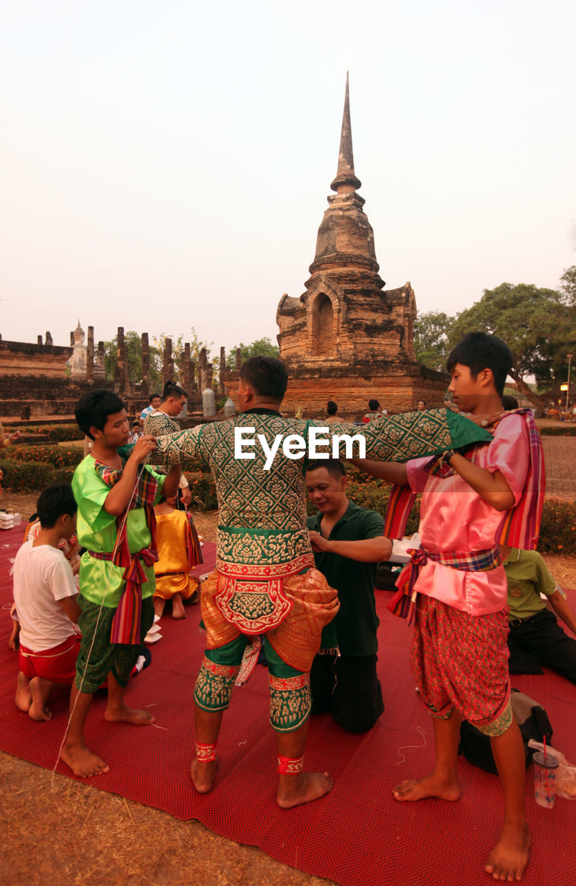 GROUP OF PEOPLE OUTSIDE TEMPLE