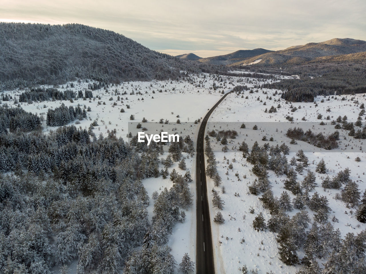 Aerial view of the road during winter with snow on dusk. lika, croatia