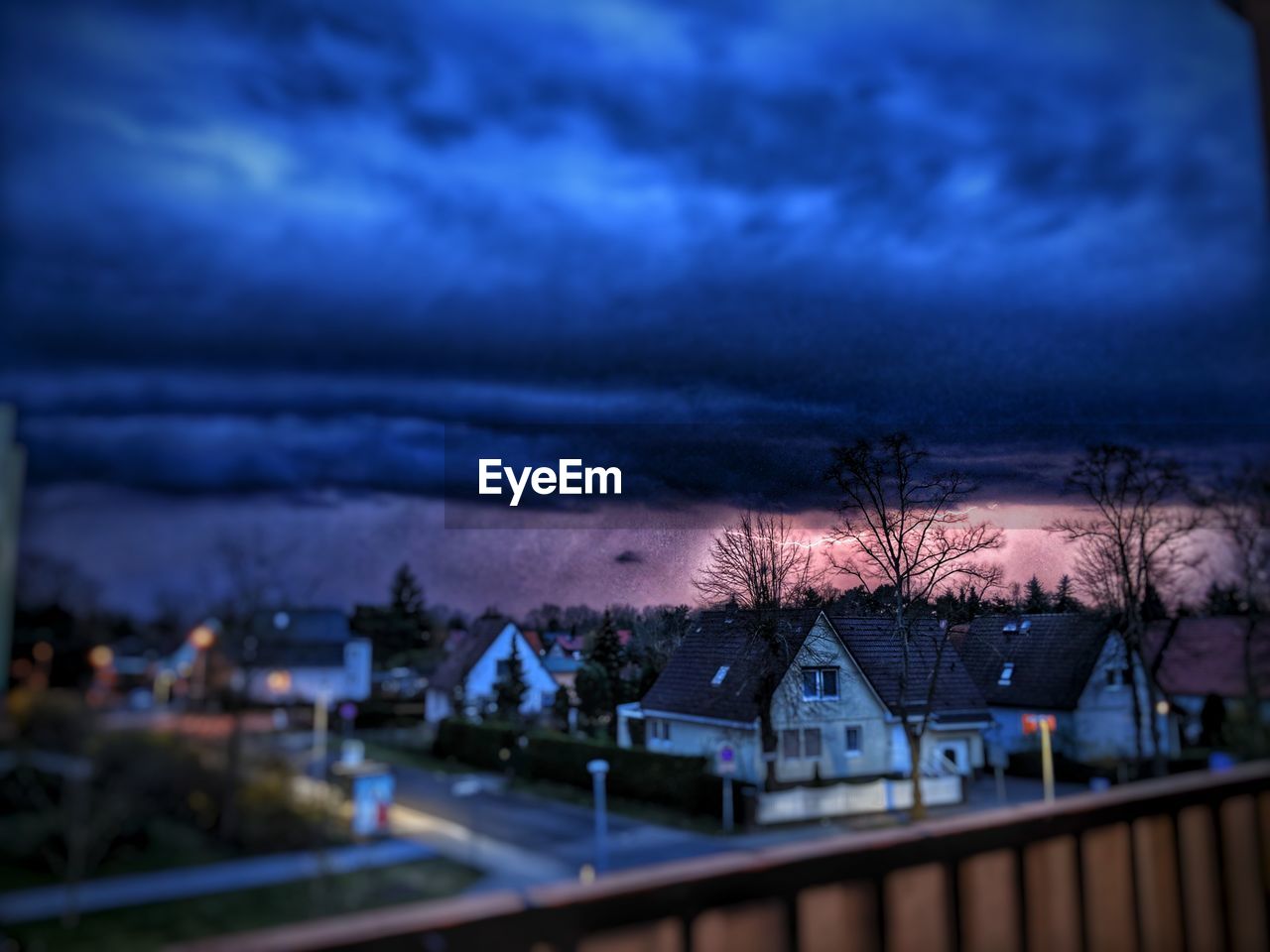 HOUSES AGAINST SKY AT NIGHT