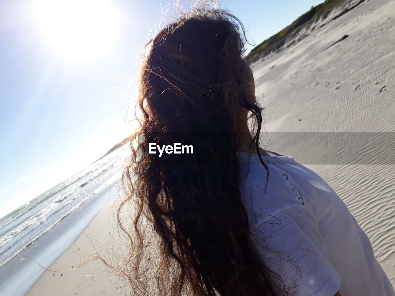 Woman on beach against clear sky