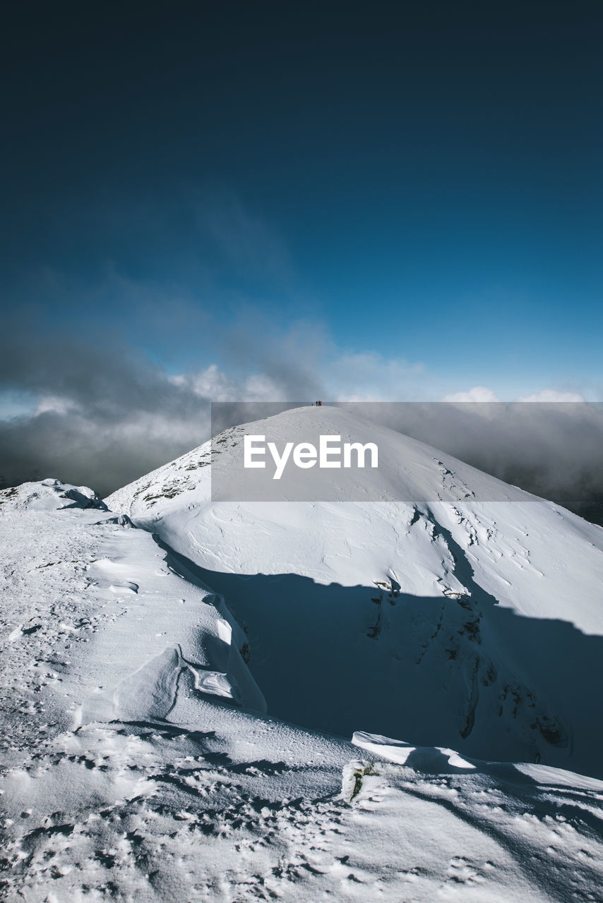 Scenic view of snowcapped mountain against sky