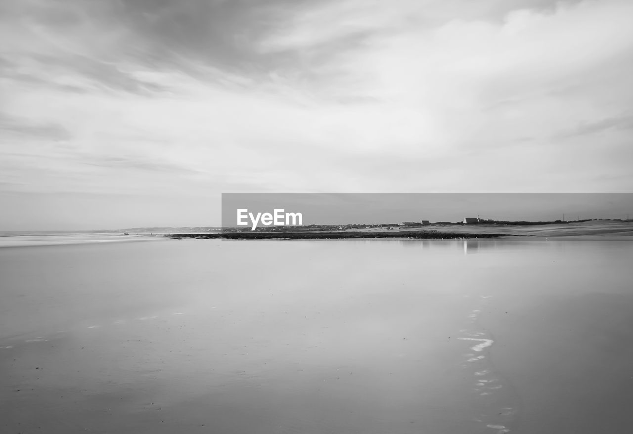 Scenic view of sea against cloudy sky