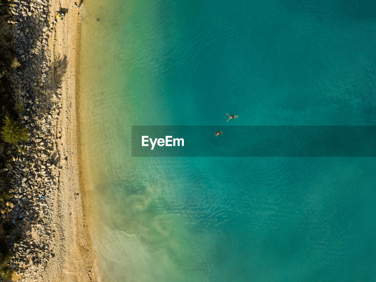 High angle top down view of beach and lake