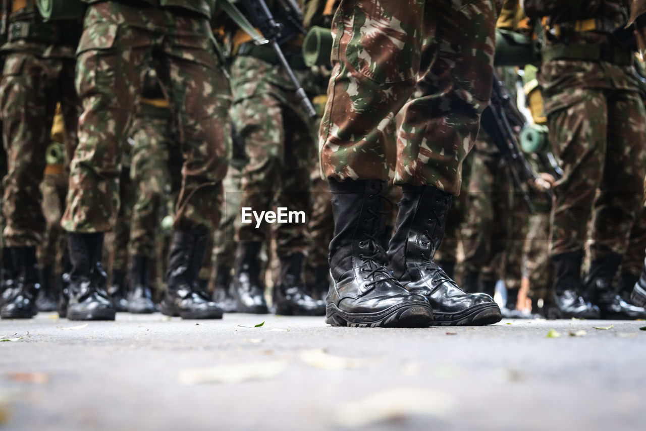 Low view of the legs of brazilian army soldiers marching through the streets of salvador