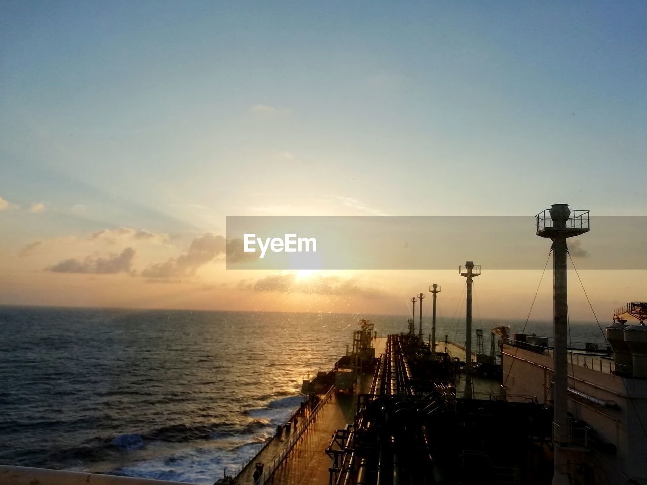 PIER ON SEA AGAINST SKY DURING SUNSET
